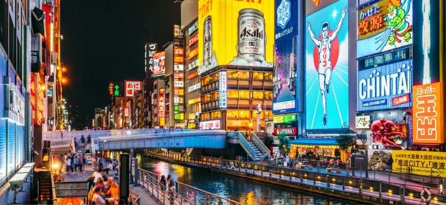 Vegan travellers exploring the bustling streets and markets of Osaka, Japan