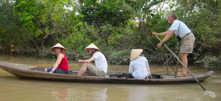 A GoVegan Travel trip to the Mekong Delta with some of the group enjoying a punt on the river