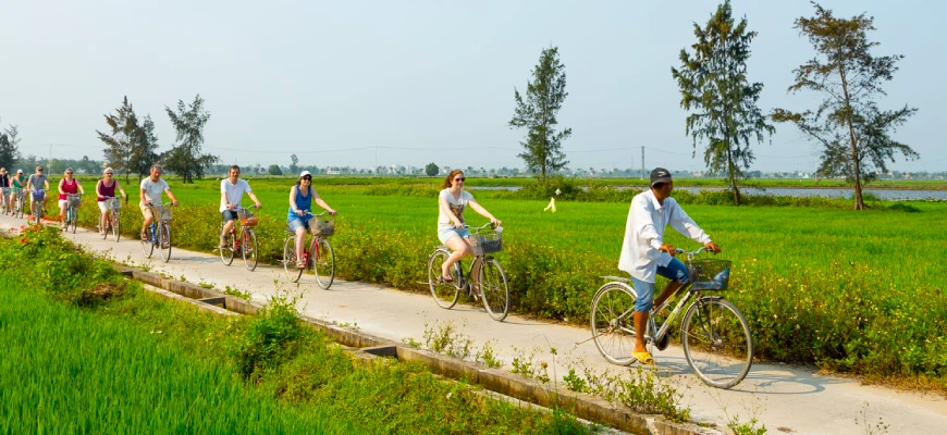 A vegan tour group anjoy a bicycle ride through the countryside before trying their hands at some Vietnamese vegan cooking