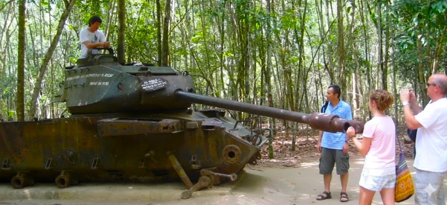 A vegan group tour of the Cuchi Tunnels and posing for photos on an American tank